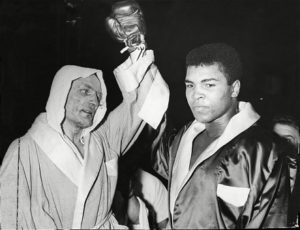 British Boxer Henry Cooper with Muhammad Ali, after Ali defeated him in 1963. Cooper went on to co-found the Anti-Nazi League.