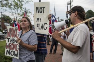 Jason Sulser shouts into a megaphone at a protester during a rally last July that he organized in his hometown of Stafford, VA that brought out neo-Nazi Ron Doggett and Scott Terry, a close friend and partner of neo-Nazi Matthew Heimbach.